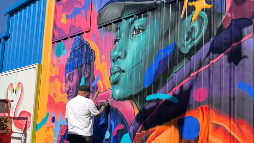 Artist Matley Hurd painting new mural Umbrella Alley Fishermans Wharf San Francisco